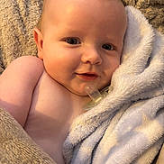 Jack is registered to the contest to win money with this photo: baby, smiling, blanket, soft, pacifier, close_up, infant, skin, cute, child, cozy, warm, portrait, comfort, expression, wrapped, young, face, happy, toddler