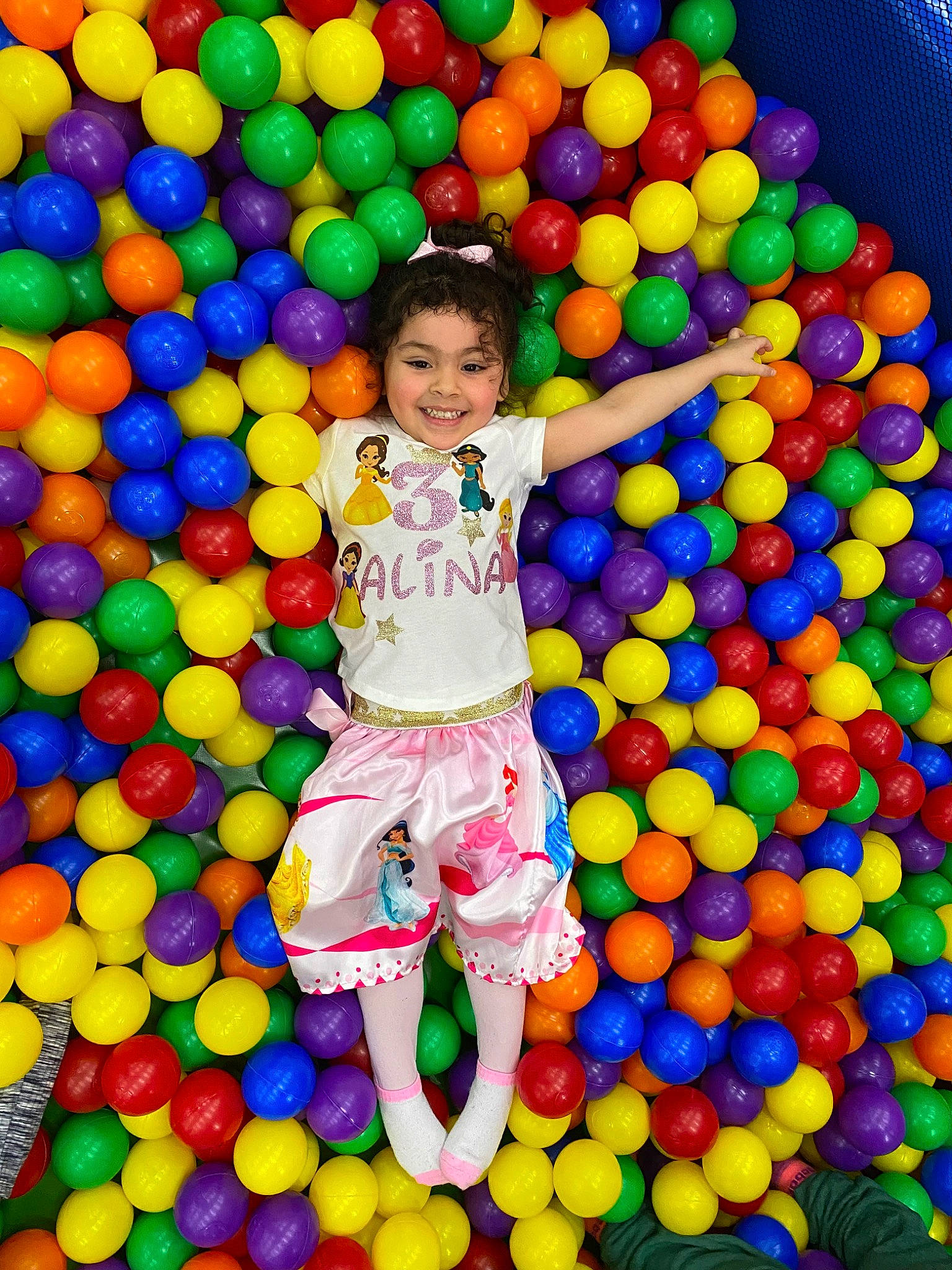 Alina is registered to the contest to win money with this photo: ball, ball_pit, child, clothing, fun, green, happy, joy, leisure, party_supply, people, people_in_nature, person, photograph, playground, recreation, shorts, smile, snapshot, t_shirt