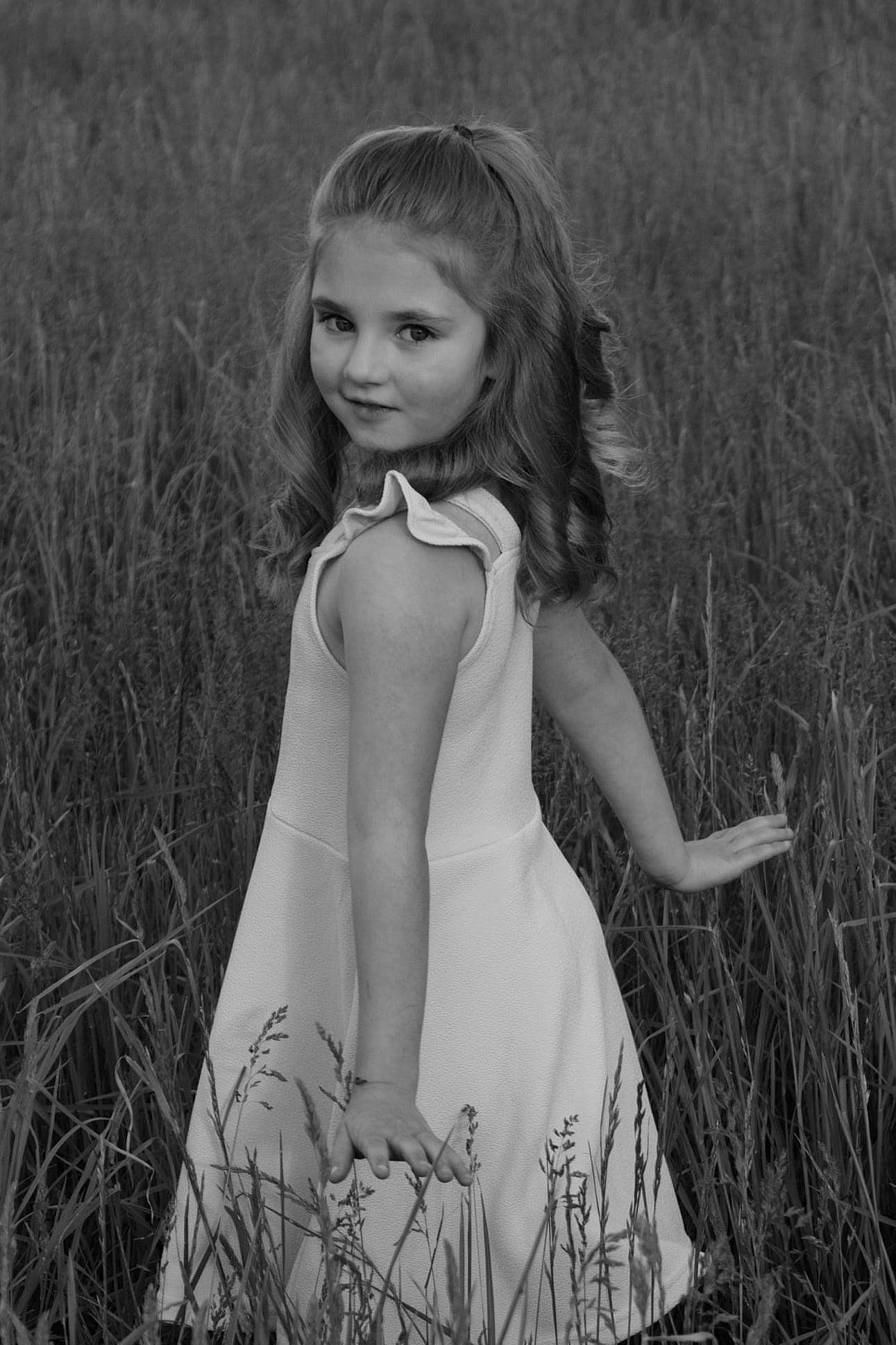 Chloie is registered to the contest to win money with this photo: black_and_white, fashion_design, flash_photography, gesture, grass, grassland, hair, hairstyle, happy, lip, meadow, neck, people_in_nature, person, photograph, plant, shoulder, standing, style, waist