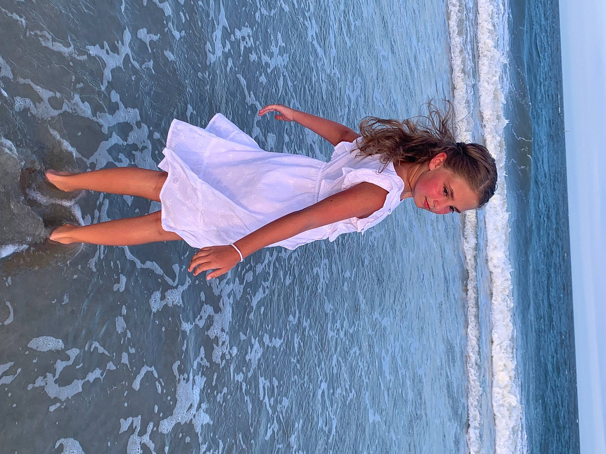 Chloie is registered to the contest to win money with this photo: azure, beach, body_of_water, cloud, dress, flash_photography, fun, gesture, happy, lake, leg, people_in_nature, person, shorts, sky, thigh, tree, waist, water, wind_wave