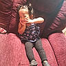 Hosmi joined the competition — help win amazing prizes! child, girl, smiling, posing, sitting, armchair, plush_furniture, maroon, hair_buns, star_pattern, top, leggings, black_shoes, indoor, cute, portrait, young_child, playful, comfortable, cozy