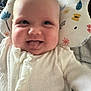 Iris joined the competition — help win amazing prizes! baby, infant, tongue_out, smiling, white_clothing, knitted, pillow, patterned_pillow, happy, cute, face, head, child, indoors, cozy, soft, closeup, person, baby_girl, baby_boy