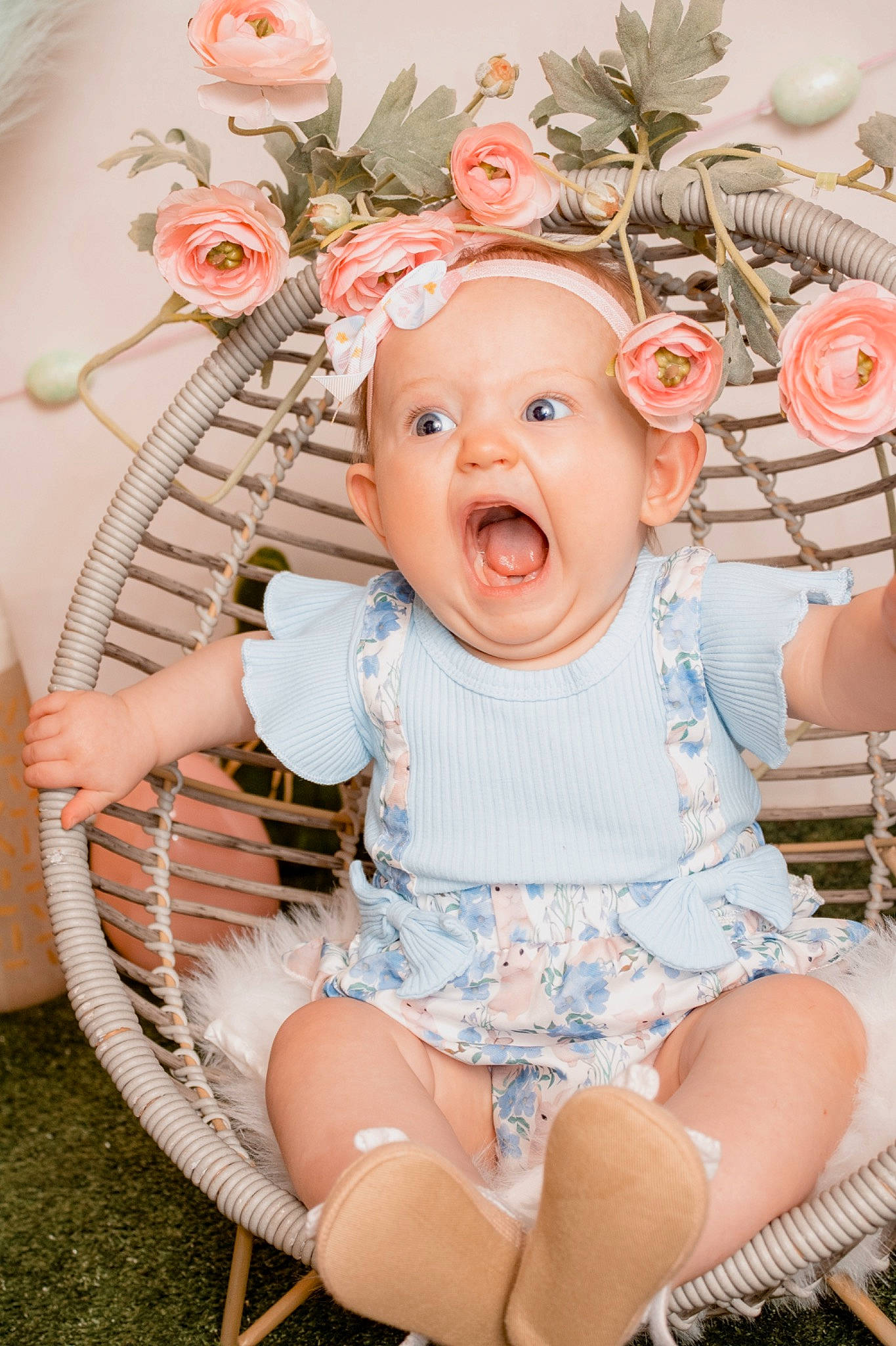 Esme is registered to the contest to win money with this photo: baby, baby_toddler_clothing, chair, child, eye, fashion_accessory, grass, happy, head, headpiece, headwear, leg, ornament, pattern, peach, person, petal, pink, rose, sitting