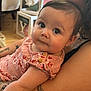 Jazlyn is registered to the contest to win money with this photo: baby, child, infant, person, arm, tattoo, clothing, pink, floral, face, eyes, indoor, furniture, blocks, decor, curious, skin, holding, portrait, closeup