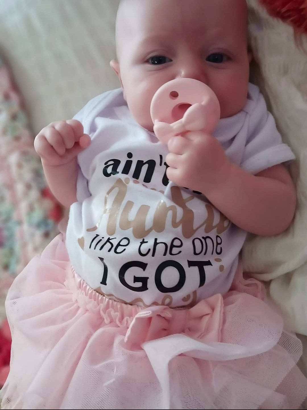 Jemma joined the competition — help win amazing prizes! baby, baby_products, baby_toddler_clothing, cheek, child, comfort, eyelash, finger, happy, lip, pattern, person, pink, product, sitting, skin, sleeve, smile, thumb, toddler