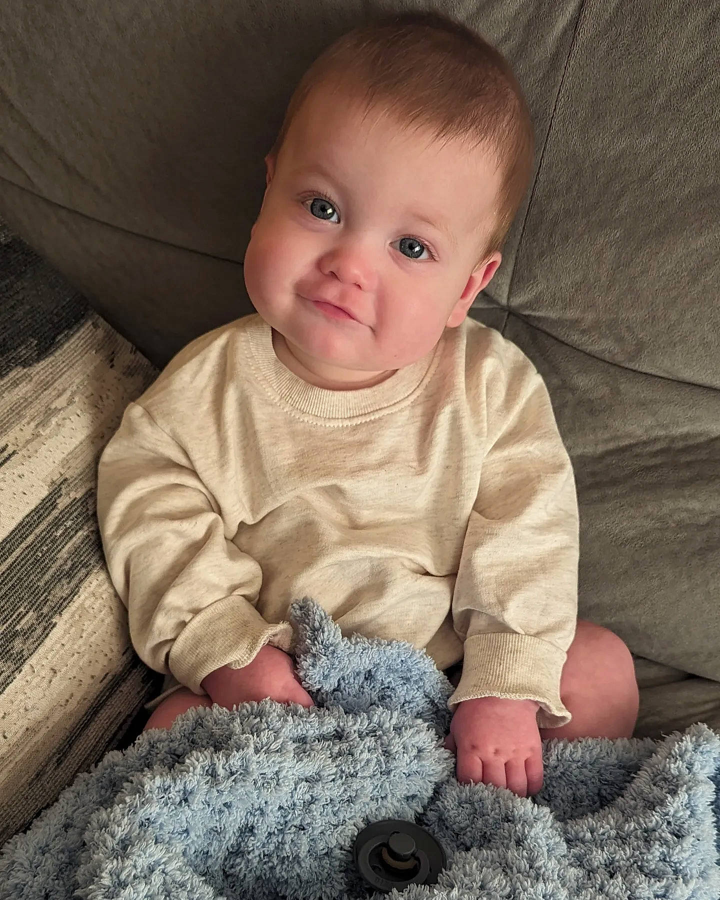 Samuel is registered to the contest to win money with this photo: baby, baby_toddler_clothing, carpet, cheek, child, comfort, finger, flooring, grey, linens, nose, pattern, person, sitting, skin, sleeve, smile, t_shirt, textile, toddler