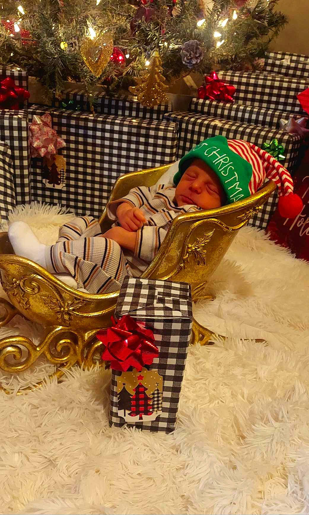 Edgar is registered to the contest to win money with this photo: child, christmas, christmas_decoration, christmas_eve, christmas_ornament, christmas_tree, event, fun, happy, holiday, interior_design, ornament, pattern, person, sitting, toddler, tradition, tree, winter