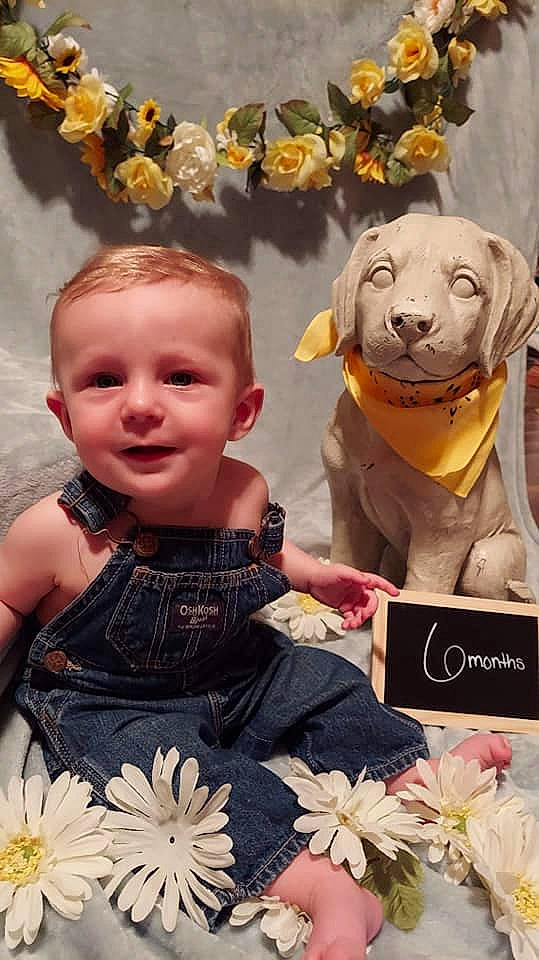 Owen is registered to the contest to win money with this photo: baby, baby_toddler_clothing, beauty, carnivore, facial_expression, fawn, happy, human, joy, organ, people, person, petal, photograph, pink, product, teddy_bear, textile, toddler, toy