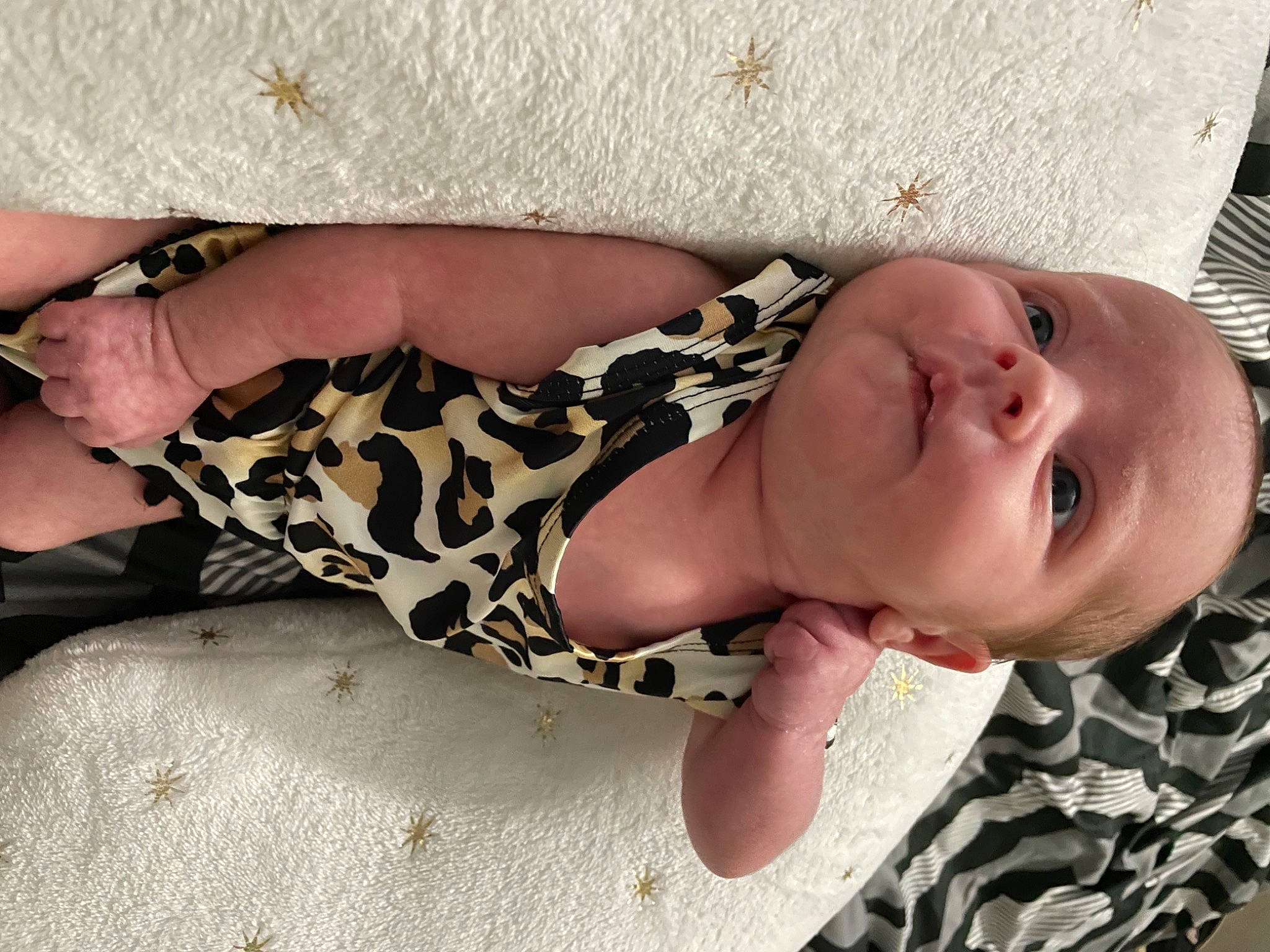 Arielle is registered to the contest to win money with this photo: baby, baby_toddler_clothing, comfort, dress, fawn, finger, hand, headgear, human_body, linens, nail, neck, pattern, person, skin, sleeve, textile, thigh, toddler, wood