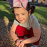 Esmae joined the competition — help win amazing prizes! child, girl, bow, rainbow_bow, unicorn_clip, red_leggings, sandals, gravel, outdoor, sunlight, smiling, crouching, grass, playground, park, cute, happy, summer, person, nature