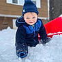 Oliver is registered to the contest to win money with this photo: toddler, child, snow, winter_clothing, hat, jacket, sled, outdoor, play, smile, face, snowy, cold, blue, red, house, tree, gloves, fun, cute