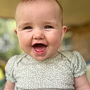 Piper joined the competition — help win amazing prizes! baby, child, smiling, face, portrait, cute, infant, happy, clothing, green, pattern, short_sleeves, skin, head, eyes, mouth, tongue, indoors, blurred_background, person
