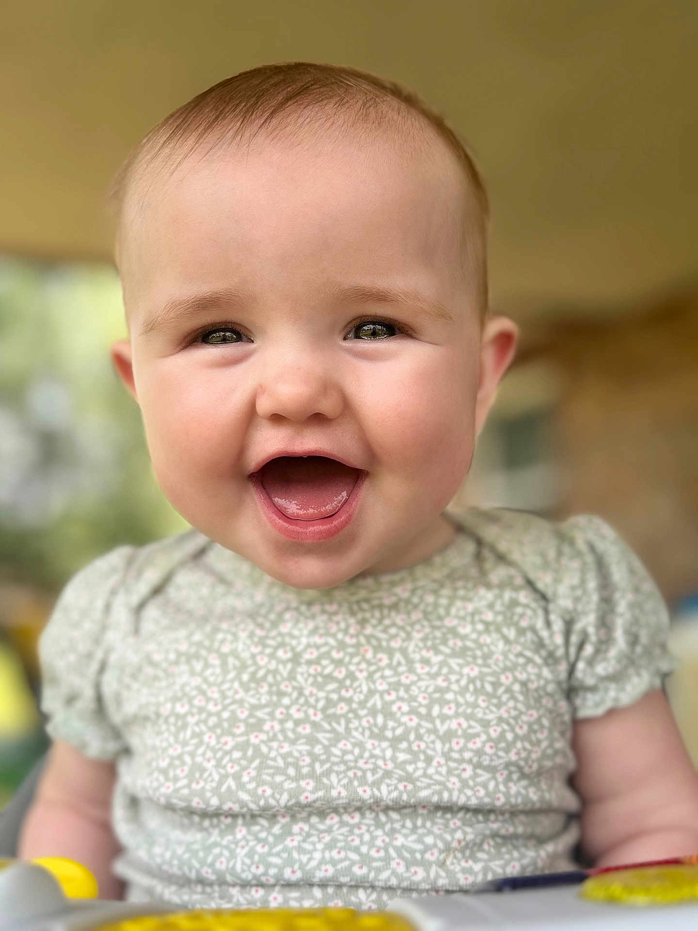 Piper joined the competition — help win amazing prizes! baby, child, smiling, face, portrait, cute, infant, happy, clothing, green, pattern, short_sleeves, skin, head, eyes, mouth, tongue, indoors, blurred_background, person