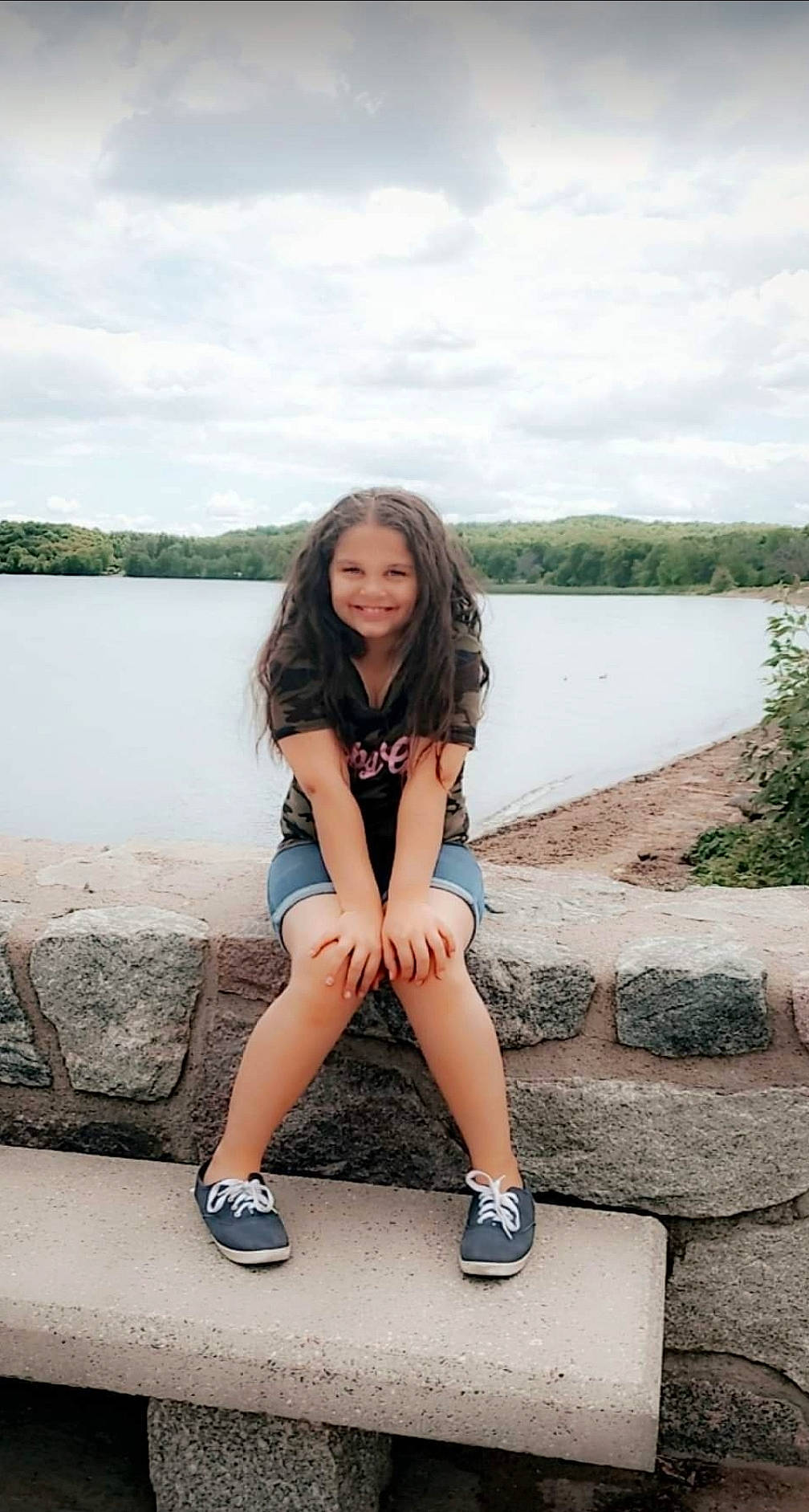 Aaliyah is registered to the contest to win money with this photo: azure, bank, cloud, cool, flash_photography, happy, joy, knee, lake, leg, leisure, people_in_nature, person, plant, shoe, shorts, sky, smile, standing, street_fashion