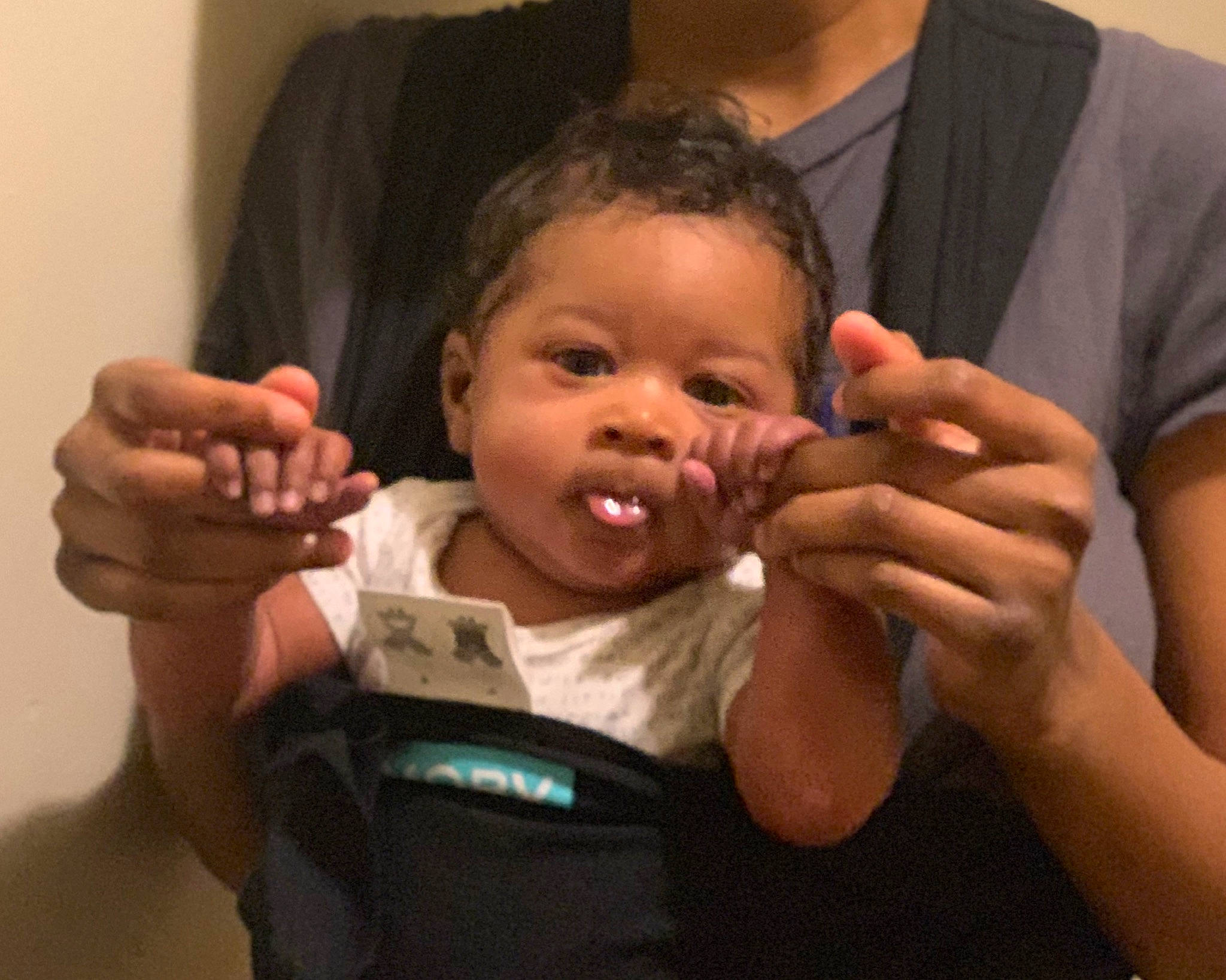 Jewel is registered to the contest to win money with this photo: arm, baby, cheek, child, ear, finger, gesture, hand, nail, nose, person, thumb, toddler