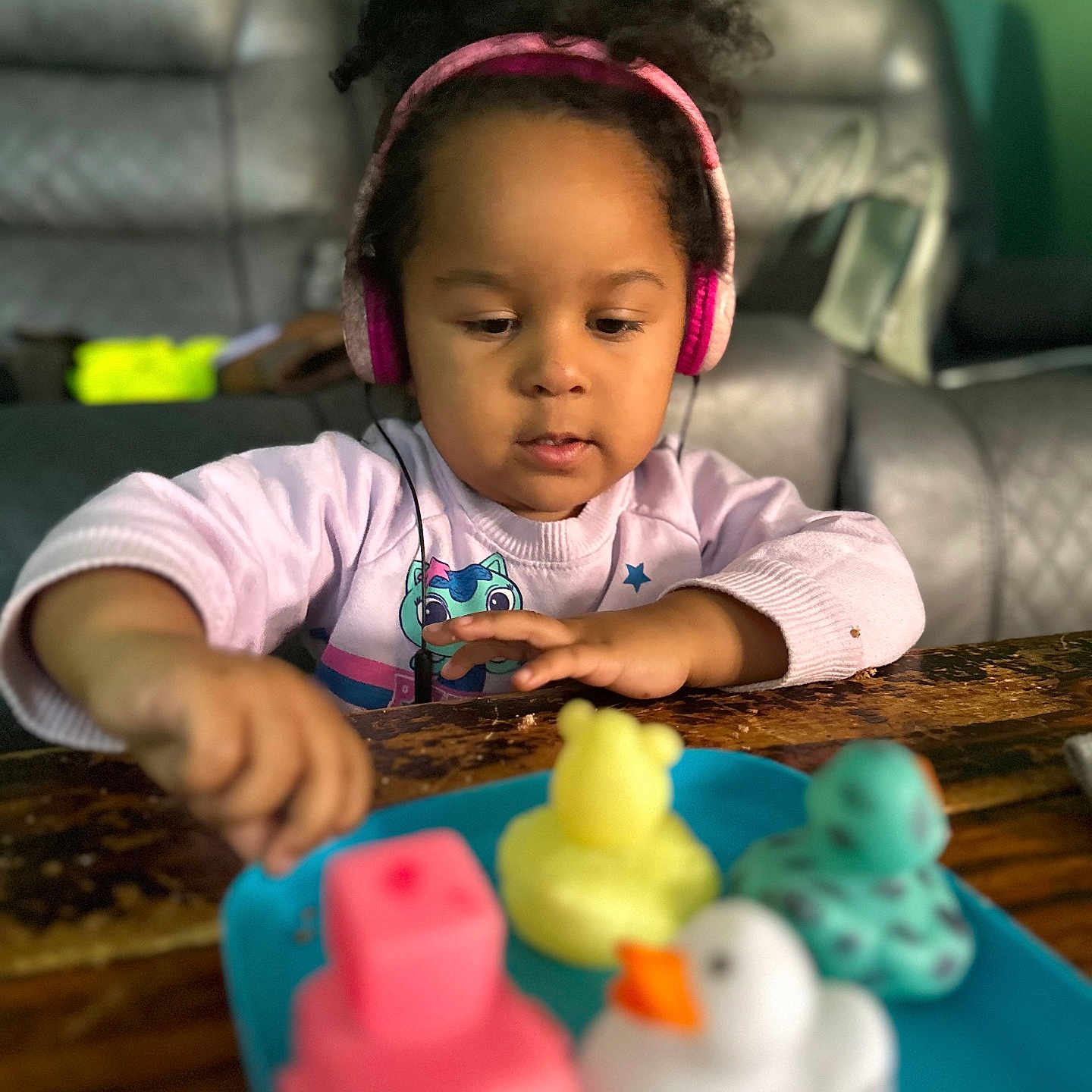Mayleen joined the competition — help win amazing prizes! bodypart, child, couch, cream, electronics, face, female, finger, furniture, girl, hand, head, headphones, peeps, person, phone, photography, portrait, table, toy