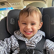 Christopher joined the competition — help win amazing prizes! toddler, child, smiling, car_seat, seatbelt, hoodie, clothing, text_pattern, indoor, car_interior, happy, face, person, young_child, safety, baby, cute, closeup, portrait, seat