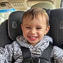 toddler, child, smiling, car_seat, seatbelt, hoodie, clothing, text_pattern, indoor, car_interior, happy, face, person, young_child, safety, baby, cute, closeup, portrait, seat