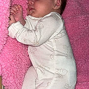 Arabella joined the competition — help win amazing prizes! baby, sleeping, blanket, pink, onesie, bunny_pattern, infant, cozy, soft_texture, cute, child, face, hand, footed_pajamas, bed, striped_sheet, resting, peaceful, indoors, portrait