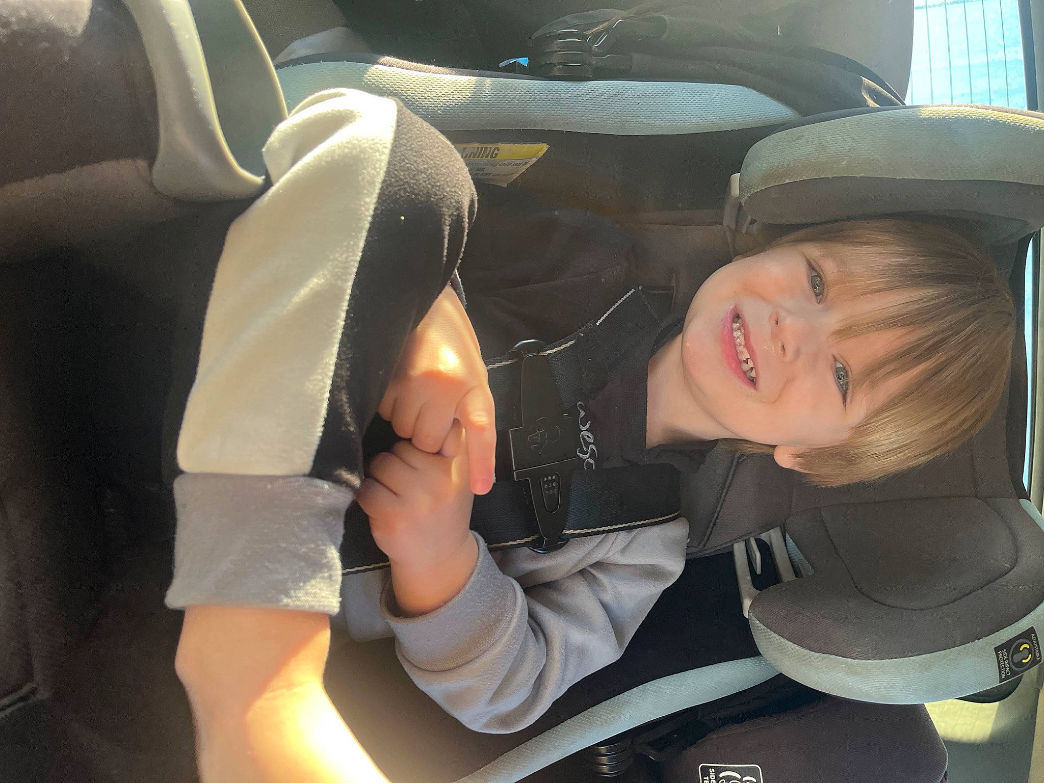 Levin is registered to the contest to win money with this photo: auto_part, automotive_design, automotive_exterior, automotive_wheel_system, car_seat, car_seat_cover, comfort, family_car, gesture, hat, head_restraint, human_leg, joy, motor_vehicle, person, personal_luxury_car, smile, steering_wheel, thigh, toddler