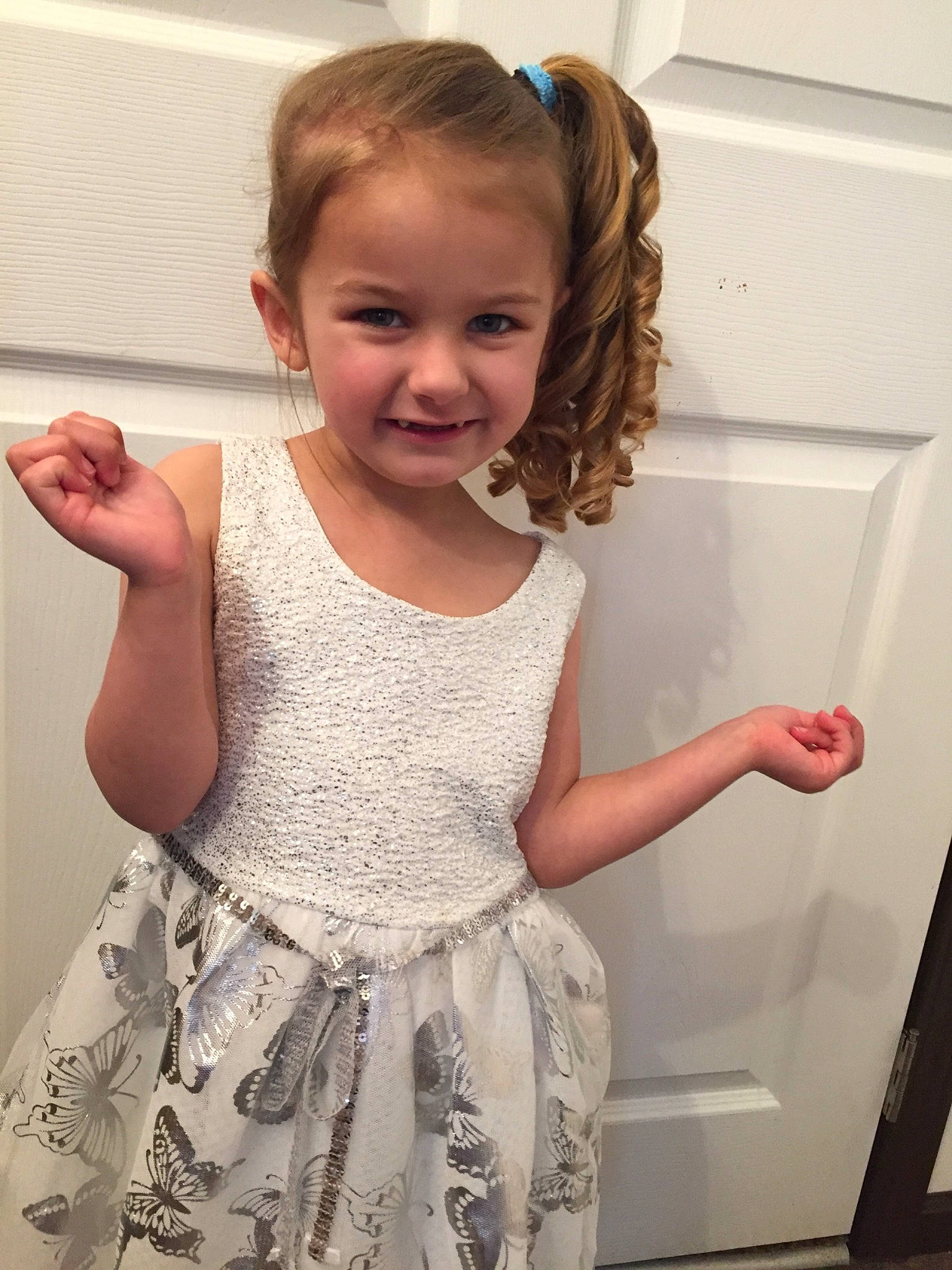 Aubriana joined the competition — help win amazing prizes! arm, blond, child, dress, ear, finger, hair, hairstyle, happy, joy, long_hair, person, room, shoulder, skin, sleeve, smile, standing, t_shirt, toddler