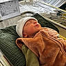 April a rejoint le concours — aidez-le/la à gagner de superbes lots ! newborn, baby, infant, sleeping, hospital, bassinet, blanket, hat, cushion, bed, rest, cozy, child, person, indoor, soft, wrapped, peaceful, medical, newborn_baby