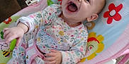 Ella is registered to the contest to win money with this photo: baby, infant, smiling, laughing, baby_bouncer, colorful, floral_onesie, indoor, carpet, toy, child, cute, happy, seat, person, playful, home, cheerful, young_child, baby_toy