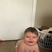Bryer joined the competition — help win amazing prizes! baby, carpet, child, clothing, crawling, cute, diaper, door, face, floor, hair, happy, indoor, infant, laundry_basket, person, plump, room, skin, smile