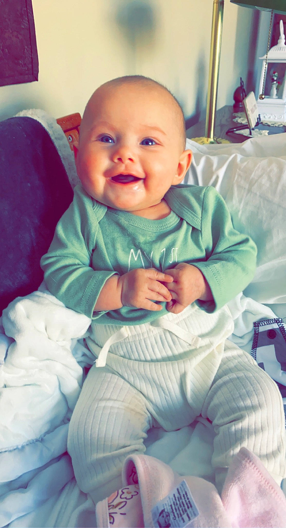 Ember is registered to the contest to win money with this photo: baby, baby_toddler_clothing, cheek, child, comfort, cool, electric_blue, eye, facial_expression, finger, fun, happy, mouth, person, product, purple, sitting, skin, smile, thumb