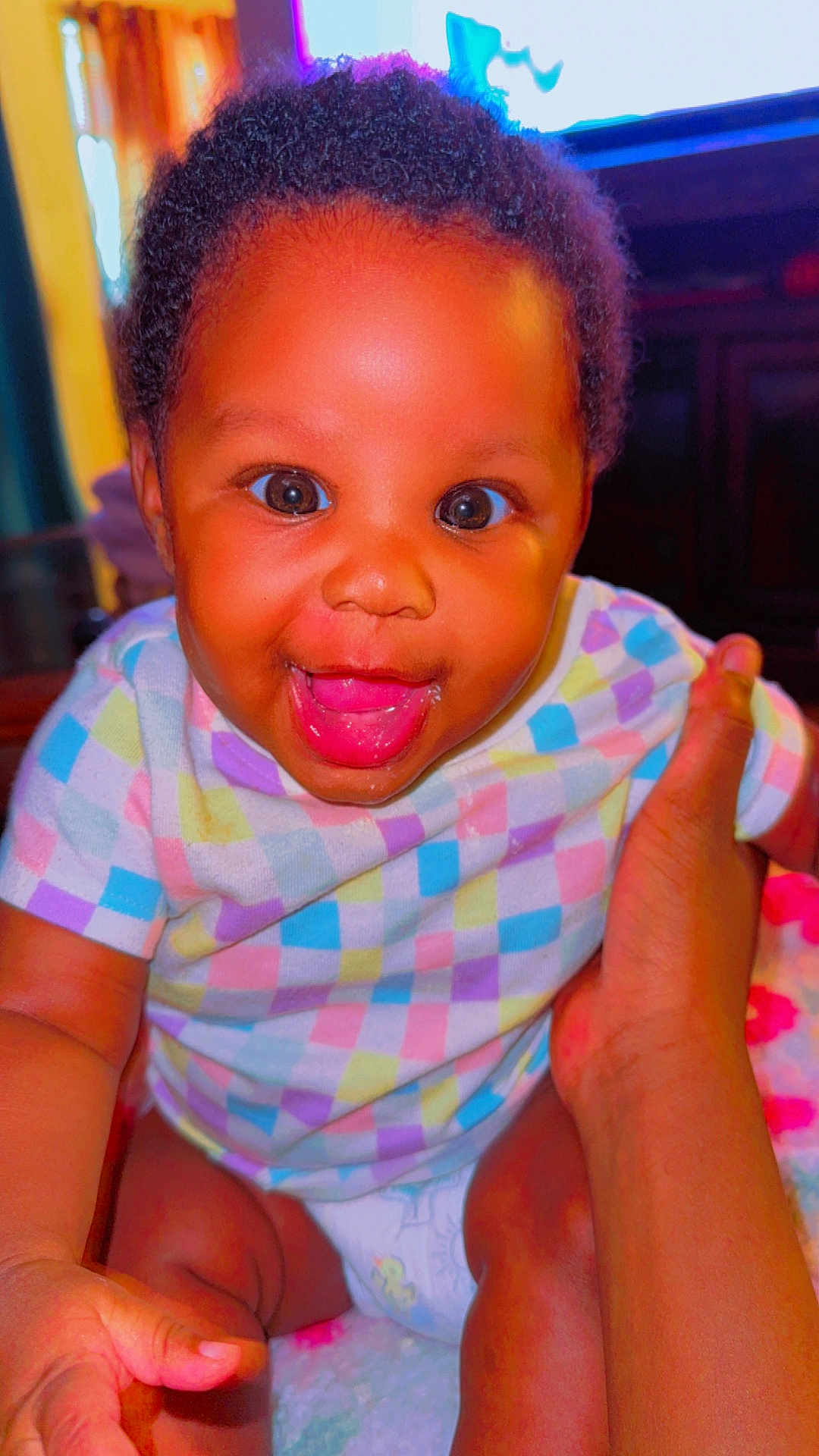 Amoura joined the competition — help win amazing prizes! baby, infant, smiling, happy, child, face, hand, clothing, colorful, diaper, cute, skin, person, portrait, indoors, babywear, expression, sitting, young_child, joy