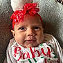 baby, infant, headband, pom_pom, red, white, smiling, face, closeup, holiday, christmas, festive, clothing, text, cute, soft_texture, portrait, indoor, cozy, happy