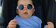 Emy participe au concours pour gagner de l'argent avec cette photo : baby, child, stroller, sunglasses, pink_glasses, clothing, seatbelt, hand, legs, cute, infant, outdoor, sunny, portrait, fashion, accessory, expression, casual, seat, person