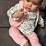 Emy a rejoint le concours — aidez-le/la à gagner de superbes lots ! baby, child, infant, pink_clothing, leopard_print, sitting, couch, indoor, curious, hand, face, person, soft_fabric, long_sleeves, foot, expression, young, casual, home, portrait
