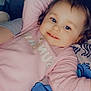 Athena participe au concours pour gagner de l'argent avec cette photo : toddler, child, smile, pink_clothing, sweatshirt, face, blue_eyes, blanket, indoor, relaxing, cute, portrait, lying_down, cozy, happy, baby, person, soft_lighting, casual, comfort