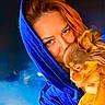 woman, dog, portrait, blue_hood, velvet, snuggling, fluffy_dog, brown_dog, closeup, warmth, affection, face, pet, animal, cozy, indoor, expression, human, cuddling, blurred_background