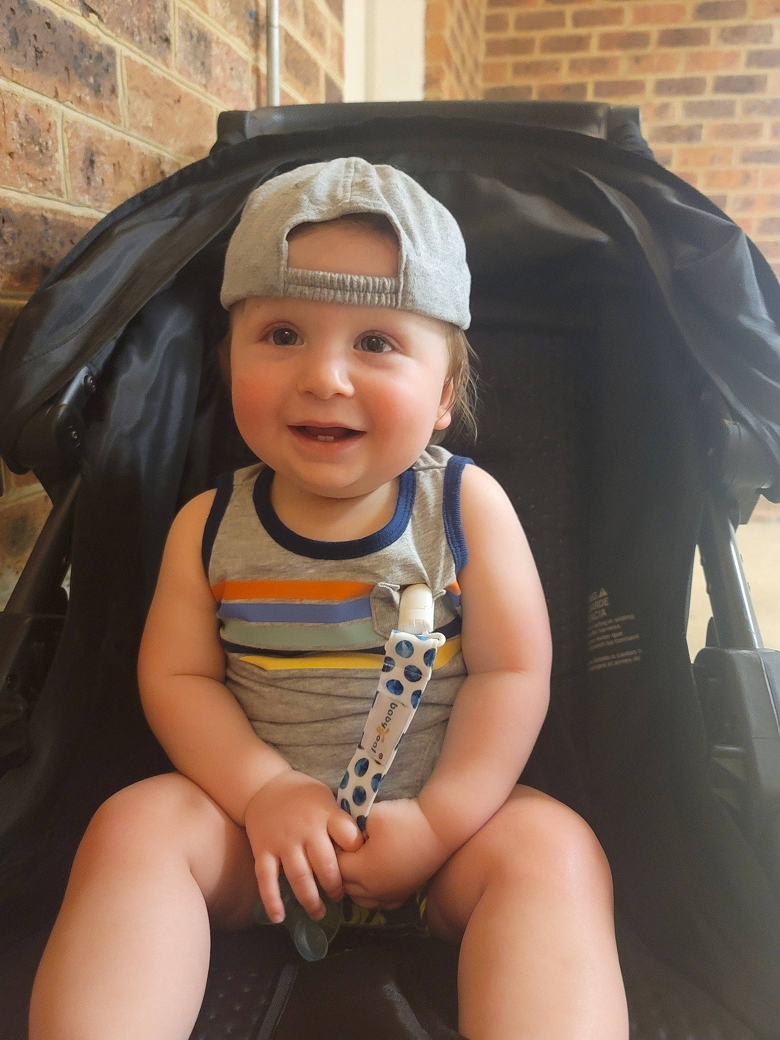 Avi is registered to the contest to win money with this photo: baby, baby_products, baby_toddler_clothing, brick, brickwork, child, comfort, fashion_accessory, fun, happy, headwear, human_leg, joy, knee, person, personal_protective_equipment, sitting, smile, thigh, thumb