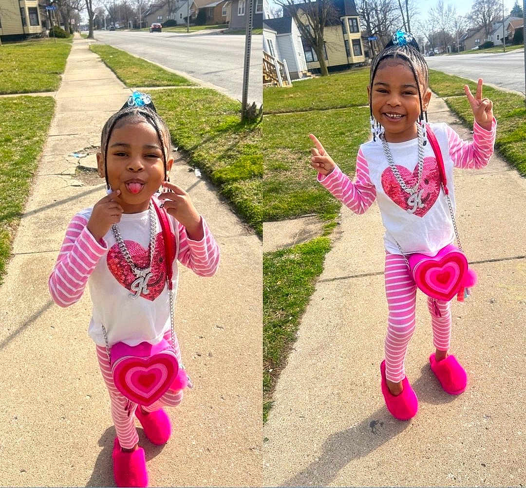 Kehlani joined the competition — help win amazing prizes! child, girl, pink, pajamas, slippers, heart_shaped_purse, sidewalk, playful, peace_sign, smile, sunny, outdoor, residential_area, happy, casual_clothing, jewelry, hair_accessory, posing, fun, daytime