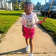 Kehlani joined the competition — help win amazing prizes! child, girl, sidewalk, peace_sign, braids, beads, pink_skirt, tie_dye_shirt, sneakers, sunny, residential_area, trees, grass, houses, car, jewelry, bracelet, necklace, outdoor, daytime