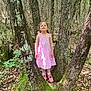 Romy a rejoint le concours — aidez-le/la à gagner de superbes lots ! child, girl, pink_dress, tree, forest, nature, moss, outdoor, smiling, standing, sunlight, leaves, bark, trunk, woodland, plants, shoes, socks, happy, young