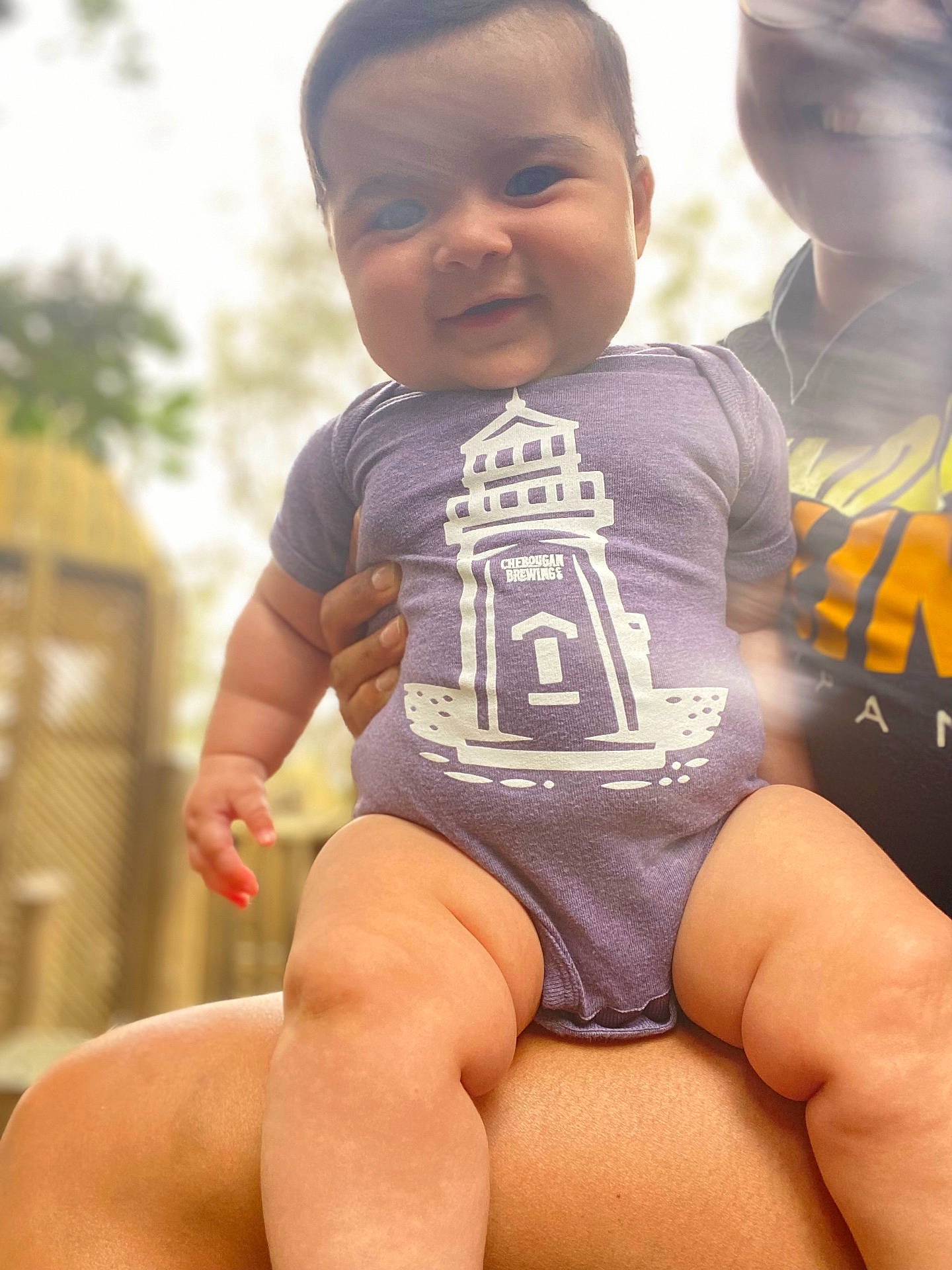 Emma joined the competition — help win amazing prizes! baby, bodypart, clothing, face, finger, hand, happy, head, mouth, pants, person, photography, portrait, shirt, shorts, sitting, sleeve, smile, t_shirt, teeth