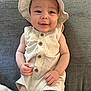 baby, infant, smiling, hat, clothing, striped, buttoned, sleeveless, cute, face, person, skin, hand, legs, lying, fabric, texture, happy, child, indoors