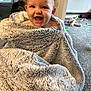 Marnie-Grace is registered to the contest to win money with this photo: baby, blanket, smiling, indoor, carpet, toy, child, happy, face, cozy, wrapped, cute, infant, carpeted_floor, soft_texture, young_child, playroom, warm, expression, portrait