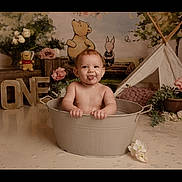 Marnie-Grace is registered to the contest to win money with this photo: baby, child, tub, bath, tongue_out, smiling, first_birthday, one, flowers, stuffed_toy, teepee, cartoon_bear, cartoon_piglet, wooden_letters, indoor, cute, portrait, playful, decor, celebration