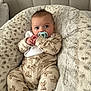 baby, bed, blanket, blue_eyes, child, comfort, cozy, cute, face, hands, indoors, infant, onesie, pacifier, portrait, resting, sleepwear, soft_texture, teddy_bear_pattern, young_baby