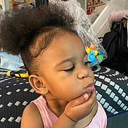 Alora is registered to the contest to win money with this photo: accessories, bed, bodypart, child, couch, cushion, earring, face, female, finger, furniture, girl, hand, head, homedecor, indoors, jewelry, person, photography, portrait