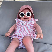 Abygaëlle a rejoint le concours — aidez-le/la à gagner de superbes lots ! baby, sunglasses, hat, pink, polka_dot, outdoor, cushion, seat, child, clothing, smile, legs, arm, cute, relaxing, fashion, accessory, portrait, summer, fun