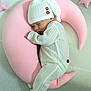 Willow joined the competition — help win amazing prizes! baby, sleeping, infant, white_outfit, knit_hat, pink_pillow, crescent_moon, star_cushions, soft_fabric, cozy, cute, child, indoors, resting, newborn, portrait, peaceful, comfortable, nursery, adorable