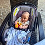 Rebecca joined the competition — help win amazing prizes! baby, car_seat, toy, blanket, chair, outdoor, pavement, stone_floor, infant, person, child, cute, seat, wicker_chair, playful, comfort, clothing, footwear, face, hand