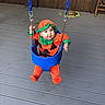 Rebecca is registered to the contest to win money with this photo: animal, baby, blue_swing, child, costume, cute, deck, fall, happy, holiday, infant, orange_clothing, outdoor, person, playful, pumpkin_costume, smile, swing, turtle, wooden_fence