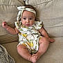 baby, infant, child, couch, sofa, headband, romper, pear_pattern, flower_pattern, beige, blanket, cute, chubby, relaxed, indoors, comfortable, portrait, sitting, cozy, soft